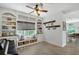 Cozy living room with built-in bookshelves, window seating and hardwood floors at 1738 Siesta Dr, Sarasota, FL 34239
