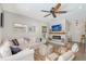 Cozy living room featuring a fireplace, comfortable seating, and stylish decor with lots of natural light at 1738 Siesta Dr, Sarasota, FL 34239
