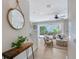 Bright living room with a view of the backyard pool through sliding glass doors and coastal-themed decor at 1738 Siesta Dr, Sarasota, FL 34239
