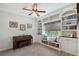 Charming living room features built-in bookcases, window seat and a piano at 1738 Siesta Dr, Sarasota, FL 34239
