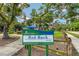 Red Rock Park signage with walking path and abundant trees at 1738 Siesta Dr, Sarasota, FL 34239