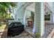 A covered patio features outdoor kitchen elements including a grill and seating at 1738 Siesta Dr, Sarasota, FL 34239