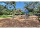 playground featuring swings and climbing equipment with mature trees at 1738 Siesta Dr, Sarasota, FL 34239