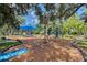 playground with a blue shade sail, swings, slides, and climbing equipment at 1738 Siesta Dr, Sarasota, FL 34239