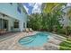 Backyard pool with ample seating, lush landscaping, and backyard, perfect for relaxation and enjoyment at 1738 Siesta Dr, Sarasota, FL 34239