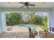 Inviting outdoor space featuring a kidney-shaped pool, tropical landscaping, and a covered patio with comfortable seating at 1738 Siesta Dr, Sarasota, FL 34239