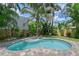 Backyard features a refreshing swimming pool with lush landscaping, offering a private outdoor retreat at 1738 Siesta Dr, Sarasota, FL 34239