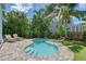 Inviting backyard with a refreshing pool surrounded by lush tropical landscaping and comfortable lounge chairs at 1738 Siesta Dr, Sarasota, FL 34239