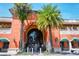 Morton's Market exterior, featuring palm trees, inviting storefronts and an American flag waving at 1738 Siesta Dr, Sarasota, FL 34239