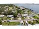 An aerial view of a single-Gathering home with a long driveway, located near a river and other houses at 204 21St Ne St, Bradenton, FL 34208