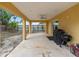 Spacious covered back porch with a ceiling fan, providing an ideal outdoor living space at 204 21St Ne St, Bradenton, FL 34208