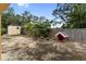 Large backyard featuring a storage shed, a dog house, and mature trees at 204 21St Ne St, Bradenton, FL 34208