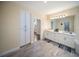 An open bathroom features double sinks, modern cabinetry, lots of counter space, and sleek tile flooring at 204 21St Ne St, Bradenton, FL 34208