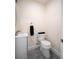 Powder room with gray wood-look floors, white vanity and toilet, and neutral paint at 204 21St Ne St, Bradenton, FL 34208