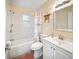 Bathroom with white tiled walls, a shower-tub combo and white vanity at 204 21St Ne St, Bradenton, FL 34208