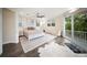 A spacious bedroom with a ceiling fan, a rug, and a sliding glass door leading to a balcony at 204 21St Ne St, Bradenton, FL 34208