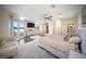 A spacious bedroom featuring a king size bed, ceiling fans, and a sliding glass door to a balcony at 204 21St Ne St, Bradenton, FL 34208
