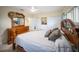 Comfortable bedroom featuring tiled flooring, ceiling fan, and wood bedroom furnishings at 204 21St Ne St, Bradenton, FL 34208