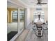 Dining area with sliders to the backyard, seating for four, and gray wood-look floors at 204 21St Ne St, Bradenton, FL 34208