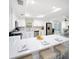 A modern kitchen boasts white cabinets, stainless steel appliances, and a spacious breakfast bar at 204 21St Ne St, Bradenton, FL 34208