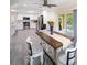 Kitchen and dining area with white cabinets, stainless steel appliances, and an island with quartz countertops at 204 21St Ne St, Bradenton, FL 34208