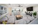 An open concept living area features a plush sofa and a modern kitchen with a breakfast bar at 204 21St Ne St, Bradenton, FL 34208
