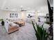 A cozy living room flows into a modern kitchen with stainless steel appliances and ample counter space at 204 21St Ne St, Bradenton, FL 34208