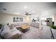 A bright living room flows into a modern kitchen with stainless steel appliances and breakfast bar seating at 204 21St Ne St, Bradenton, FL 34208