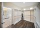 Spacious walk-in closet features modern custom storage, hardwood floors, and bright lighting at 204 21St Ne St, Bradenton, FL 34208