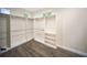 Bright walk-in closet has custom storage, lots of space, hardwood floors, and bright lighting at 204 21St Ne St, Bradenton, FL 34208