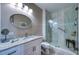 Well-lit bathroom features a glass-enclosed shower, granite countertop vanity, and modern fixtures for a luxurious experience at 210 3Rd W St # 8308, Bradenton, FL 34205