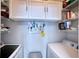 Convenient laundry room with washer, dryer, and ample storage shelving at 210 3Rd W St # 8308, Bradenton, FL 34205
