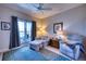 Cozy living room features comfortable seating, a ceiling fan, and a bright window for relaxing and entertaining guests at 210 3Rd W St # 8308, Bradenton, FL 34205