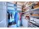 Organized walk-in closet with shelving, hanging rods, and efficient storage solutions at 210 3Rd W St # 8308, Bradenton, FL 34205