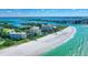 Stunning aerial view of the resort, beach, and turquoise waters at 225 Sands Point Rd # 6201, Longboat Key, FL 34228