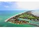 Wide aerial shot of a coastal community with a golf course nestled along the beach at 225 Sands Point Rd # 6201, Longboat Key, FL 34228