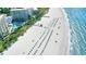 Expansive beach with many lounge chairs and umbrellas at 225 Sands Point Rd # 6201, Longboat Key, FL 34228