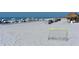 White sand beach with lounge chairs and recreational equipment at 225 Sands Point Rd # 6201, Longboat Key, FL 34228