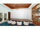 Elegant dining room featuring modern lighting, wine storage, and seating for ten at 225 Sands Point Rd # 6201, Longboat Key, FL 34228