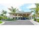 Stunning covered building entrance with palm trees and manicured landscaping at 225 Sands Point Rd # 6201, Longboat Key, FL 34228