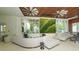 Spacious lounge with decorative ceiling fans, large windows, and comfortable seating at 225 Sands Point Rd # 6201, Longboat Key, FL 34228