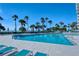 Resort pool with blue lounge chairs, umbrellas, and clear blue water ready for relaxation at 225 Sands Point Rd # 6201, Longboat Key, FL 34228