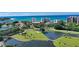 Stunning aerial view of a golf course and waterfront homes along the coast at 225 Sands Point Rd # 7205, Longboat Key, FL 34228
