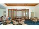 Spacious restaurant area with decorative carpets, modern furniture and a view to the private meeting room at 225 Sands Point Rd # 7205, Longboat Key, FL 34228