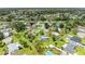 An aerial view shows a desirable neighborhood with spacious lots and lovely landscaping at 237 Saxon Cir, Venice, FL 34293