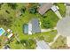 An aerial view showcasing a backyard pool and outdoor living area on a well manicured lot at 237 Saxon Cir, Venice, FL 34293
