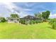 Spacious backyard showcasing a screened-in pool area and well-maintained lawn at 237 Saxon Cir, Venice, FL 34293