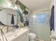 Bathroom with tropical wallpaper, vanity, and glass door shower stall at 237 Saxon Cir, Venice, FL 34293