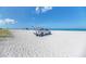 Beautiful sandy beach with a lifeguard truck parked in the sand with a blue sky overhead at 237 Saxon Cir, Venice, FL 34293
