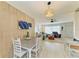 Open-concept dining area with a stylish light fixture and a view into the living room at 237 Saxon Cir, Venice, FL 34293